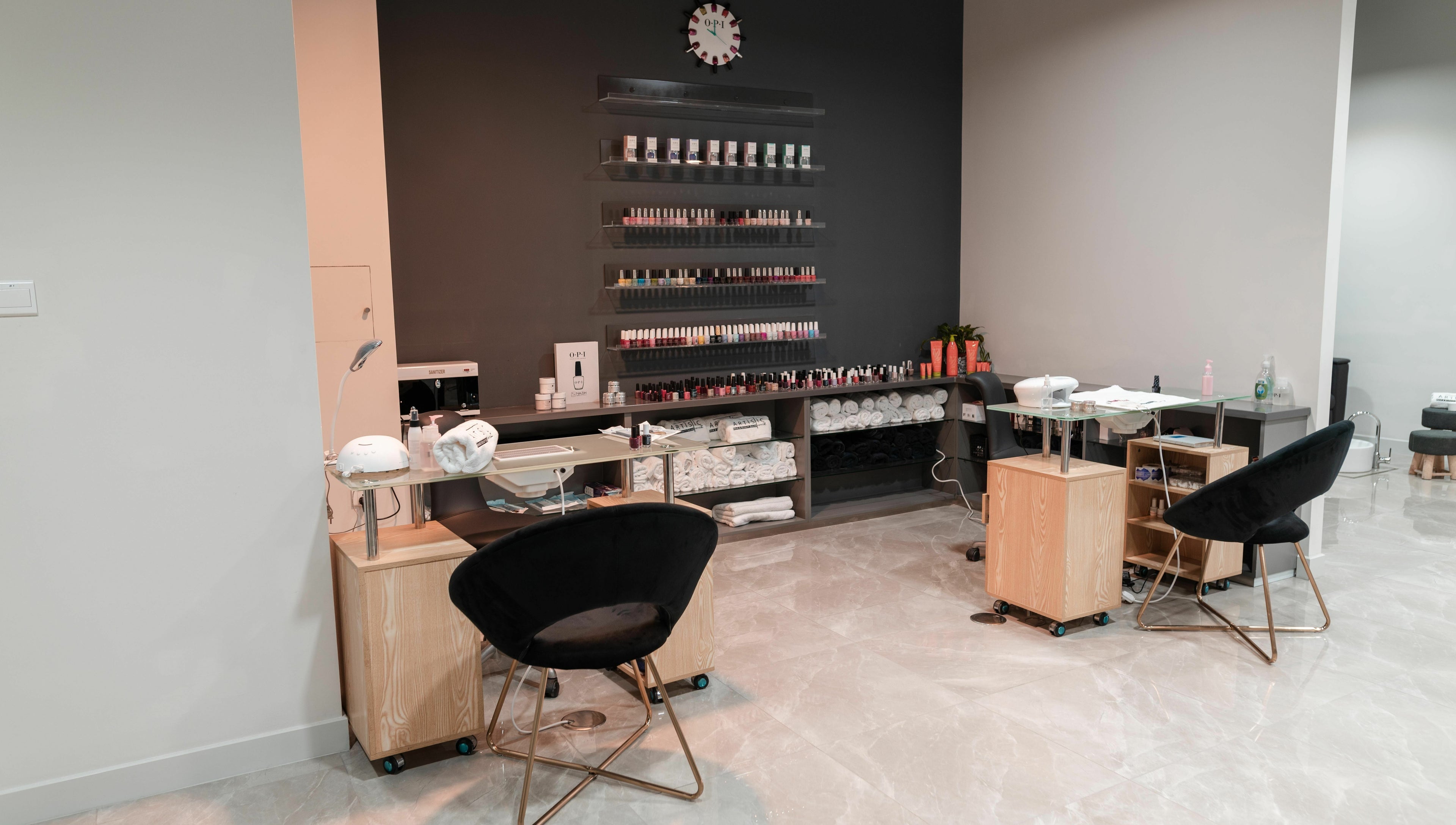 Modern nail salon interior at Artistic Trendz Hair and Beauty Salon, Dubai, AE showcasing manicure stations.