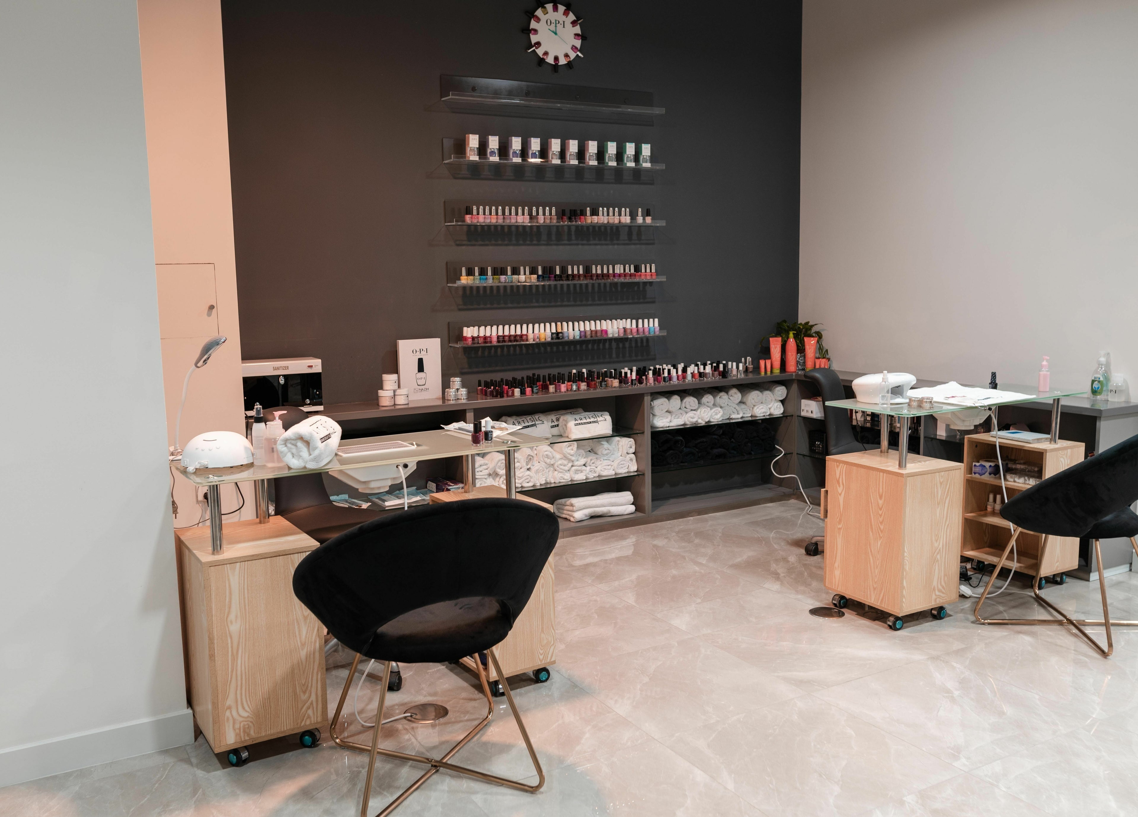 Modern nail salon interior at Artistic Trendz Hair and Beauty Salon, Dubai, AE showcasing manicure stations.