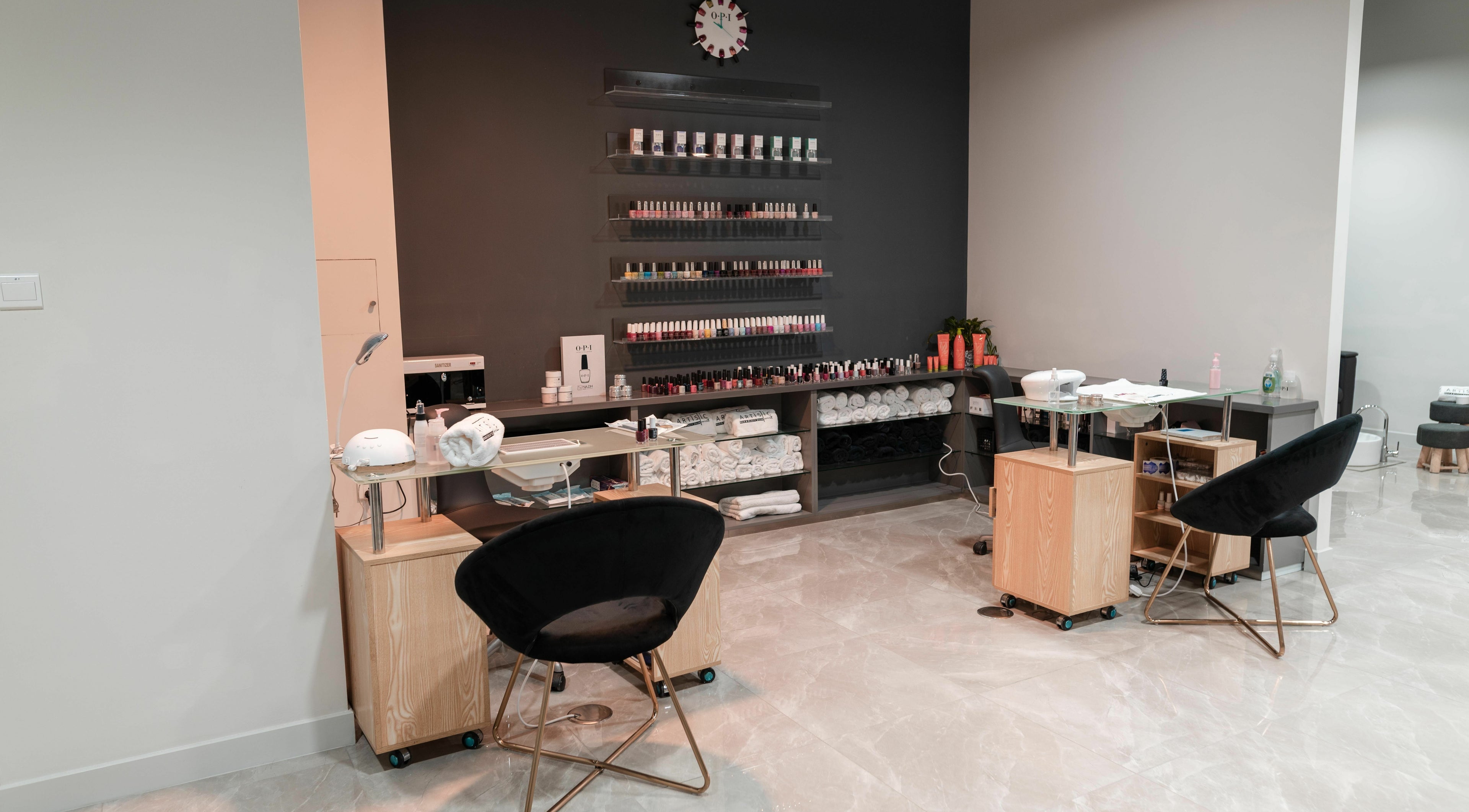 Modern nail salon interior at Artistic Trendz Hair and Beauty Salon, Dubai, AE showcasing manicure stations.