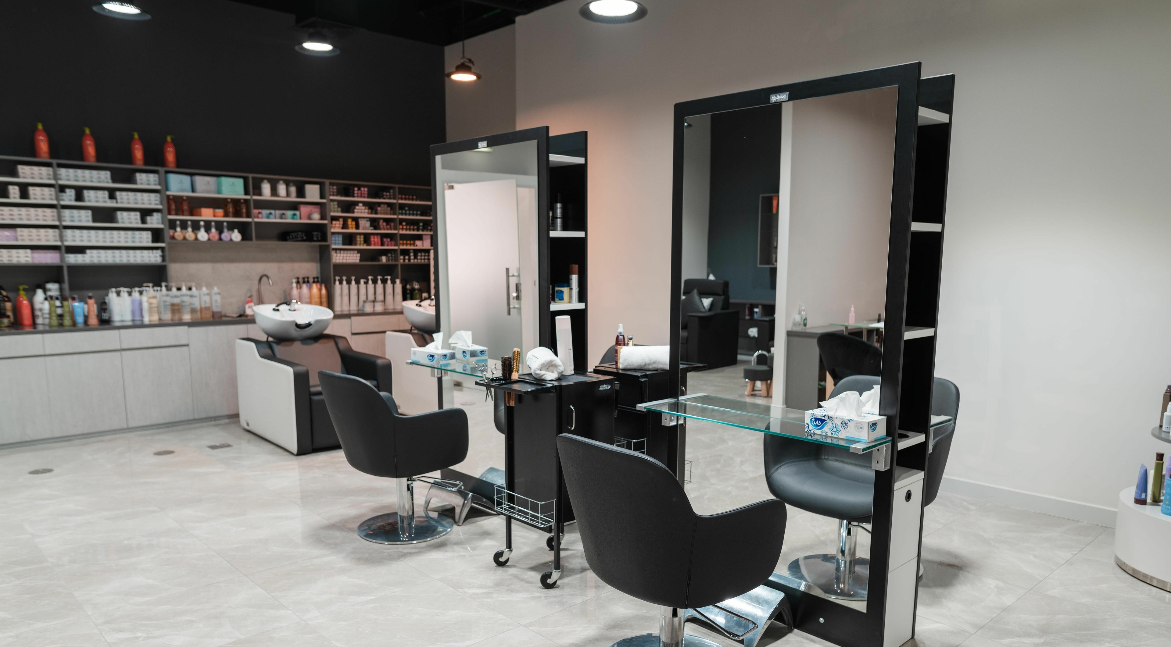 Contemporary salon interior at Artistic Trendz Hair and Beauty Salon, Dubai, AE, showcasing sleek styling stations.