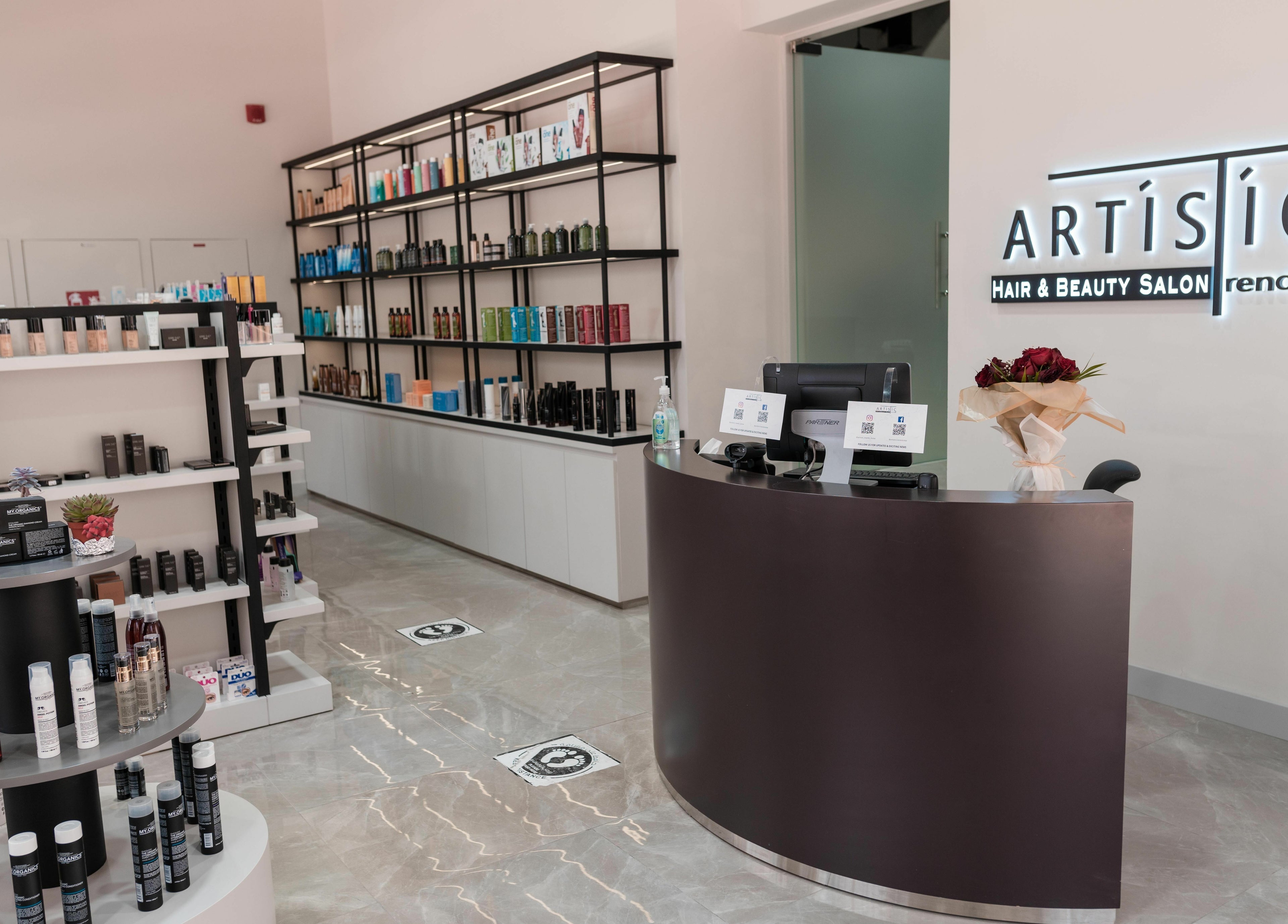 Reception area of Artistic Trendz Hair and Beauty Salon in Dubai, AE, showcasing elegant product displays.