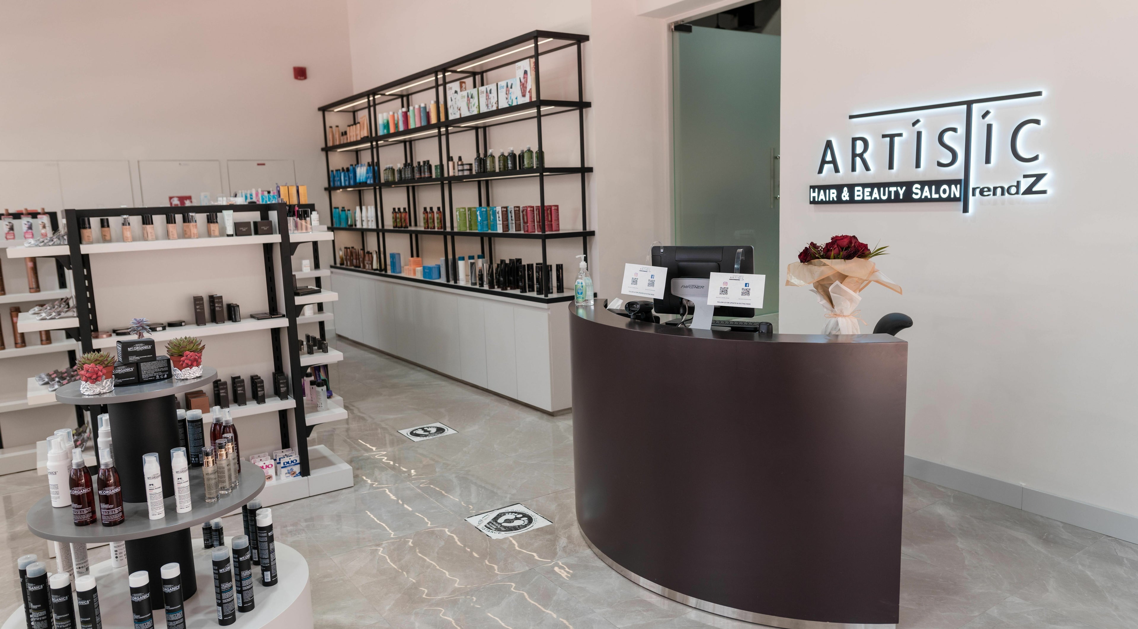 Reception area of Artistic Trendz Hair and Beauty Salon in Dubai, AE, showcasing elegant product displays.