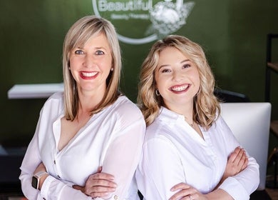 Team members at Perfectly Beautiful in Bloemfontein, Free State, ZA, smiling warmly in white shirts.