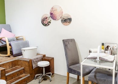 Cozy spa setup at Perfectly Beautiful, Bloemfontein, Free State, ZA with plush chairs and nail station.