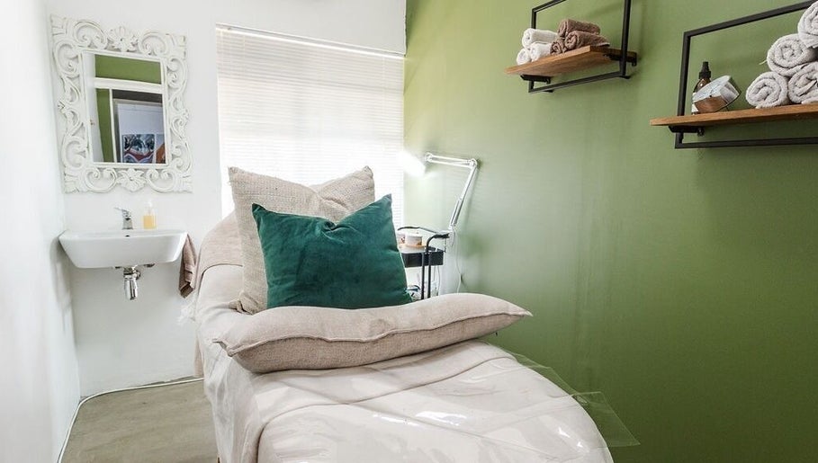 Cozy spa room at Perfectly Beautiful in Bloemfontein, Free State, ZA, with green pillows and decor.