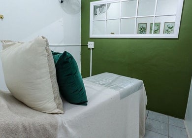 Relaxing massage room at Perfectly Beautiful in Bloemfontein, Free State, ZA featuring calming green decor.
