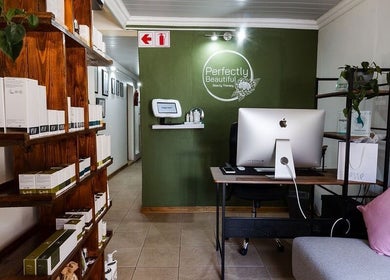 Reception area at Perfectly Beautiful in Bloemfontein, Free State, ZA featuring modern design and beauty products.