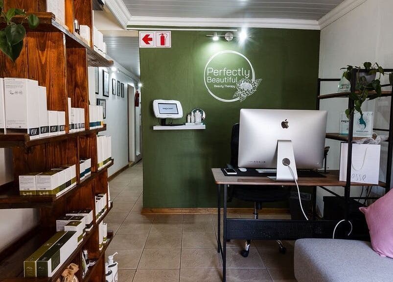 Welcoming lobby of Perfectly Beautiful in Bloemfontein, Free State, ZA with computer and display shelves.
