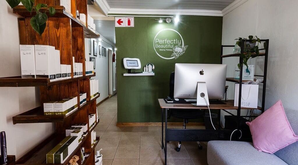 Welcoming lobby of Perfectly Beautiful in Bloemfontein, Free State, ZA with computer and display shelves.