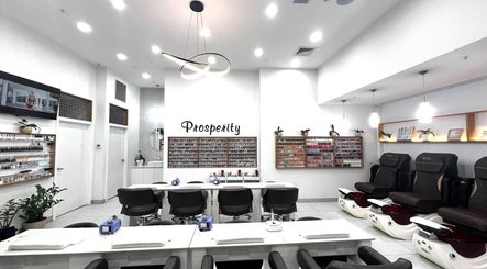 Modern interior of Prosperity Nails & Beauty in North Melbourne, Victoria, AU, showcasing manicure stations and pedi chairs.