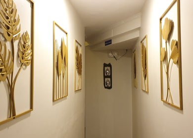 Elegant hallway at Northern Spa - Cabanatuan City with golden leaf wall art. Cabanatuan City, Central Luzon, PH.