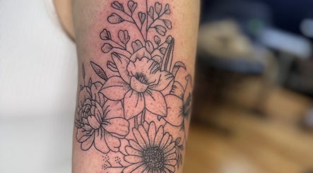 Exquisite floral tattoo artwork from Asatru Tattoos in Cardiff, Wales, GB. Showcasing delicate flower designs.