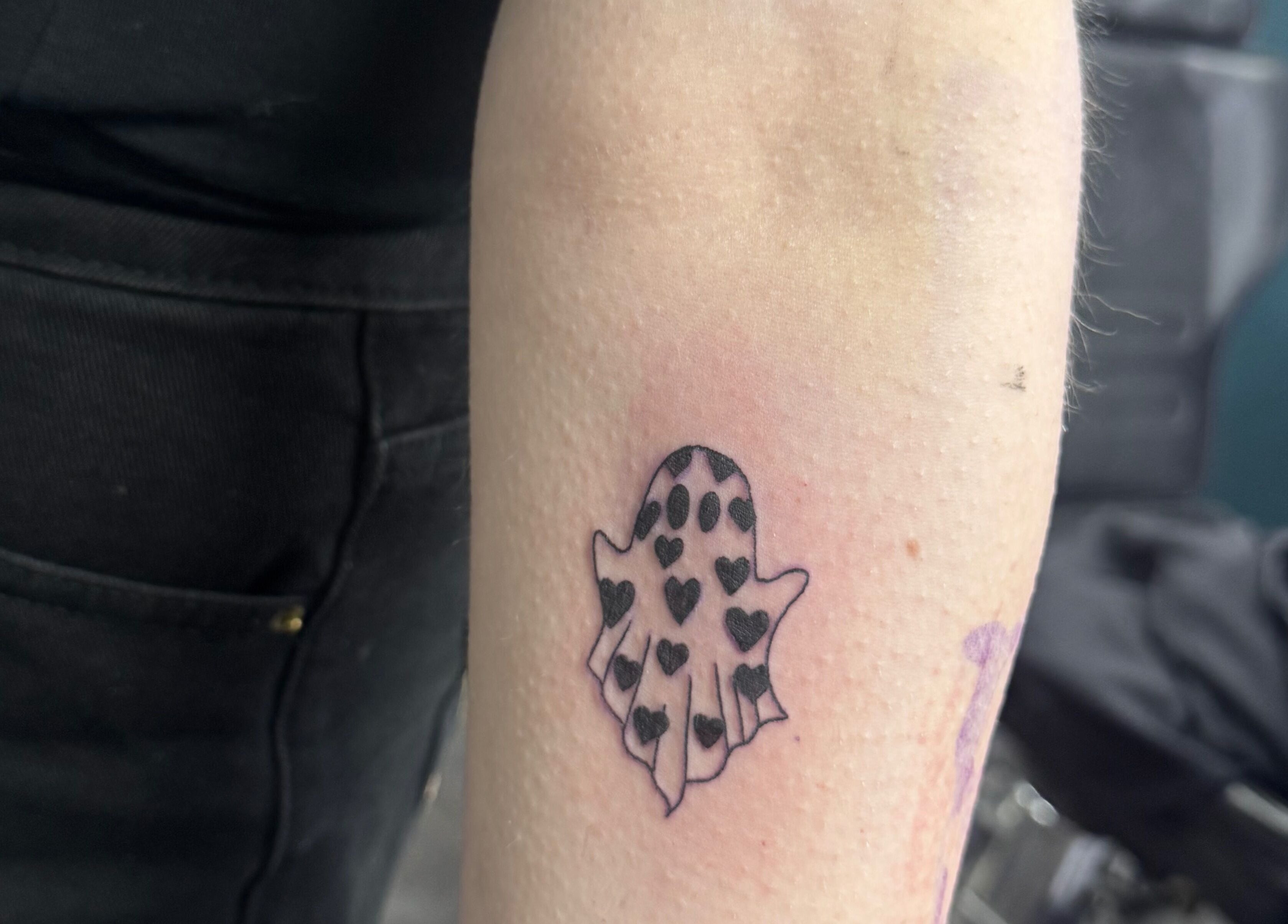 A heart pattern ghost tattoo on an arm at Asatru Tattoos, Cardiff, Wales, GB.