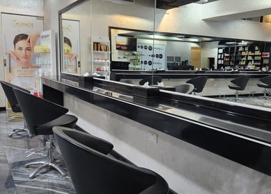 Modern salon interior with sleek black chairs and products at Flair Beauty Salon, Abu Dhabi, Abu Dhabi, AE.