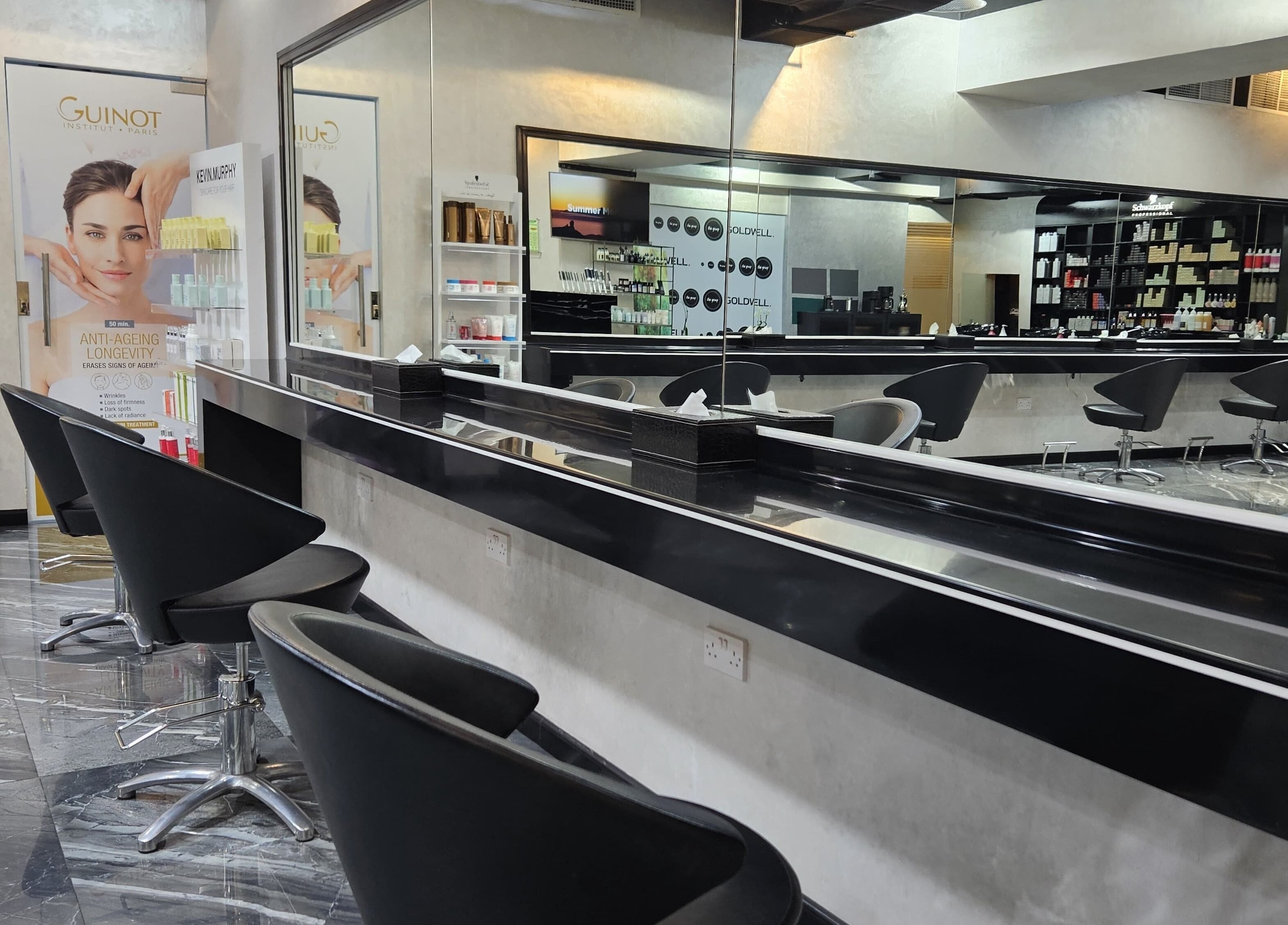 Modern salon interior with sleek black chairs and products at Flair Beauty Salon, Abu Dhabi, Abu Dhabi, AE.