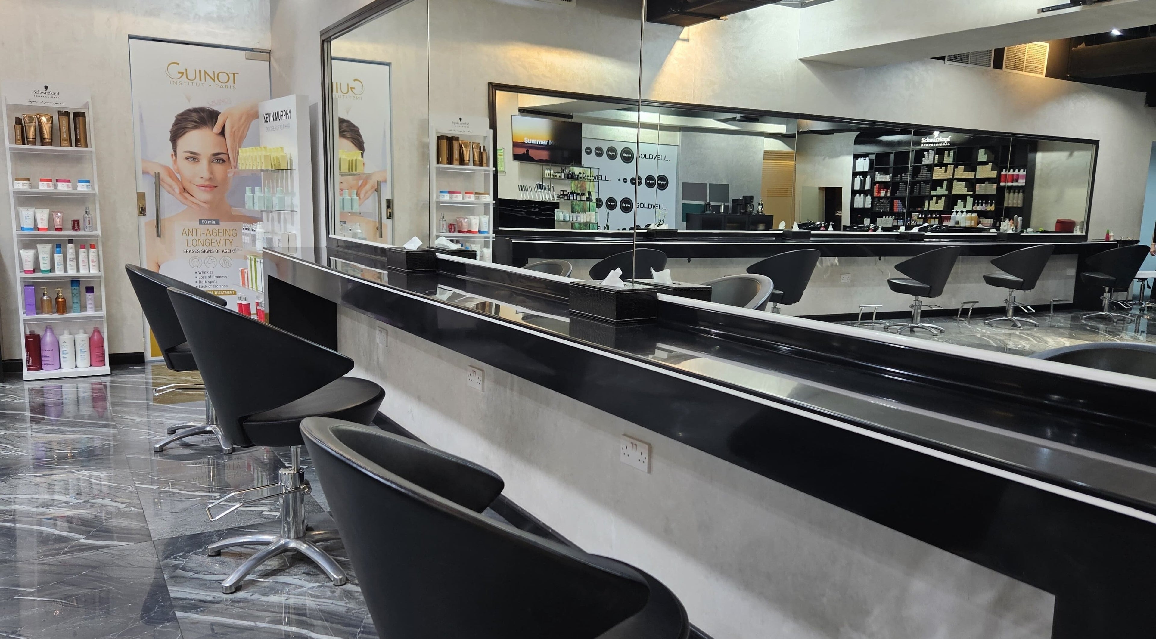 Modern salon interior with sleek black chairs and products at Flair Beauty Salon, Abu Dhabi, Abu Dhabi, AE.