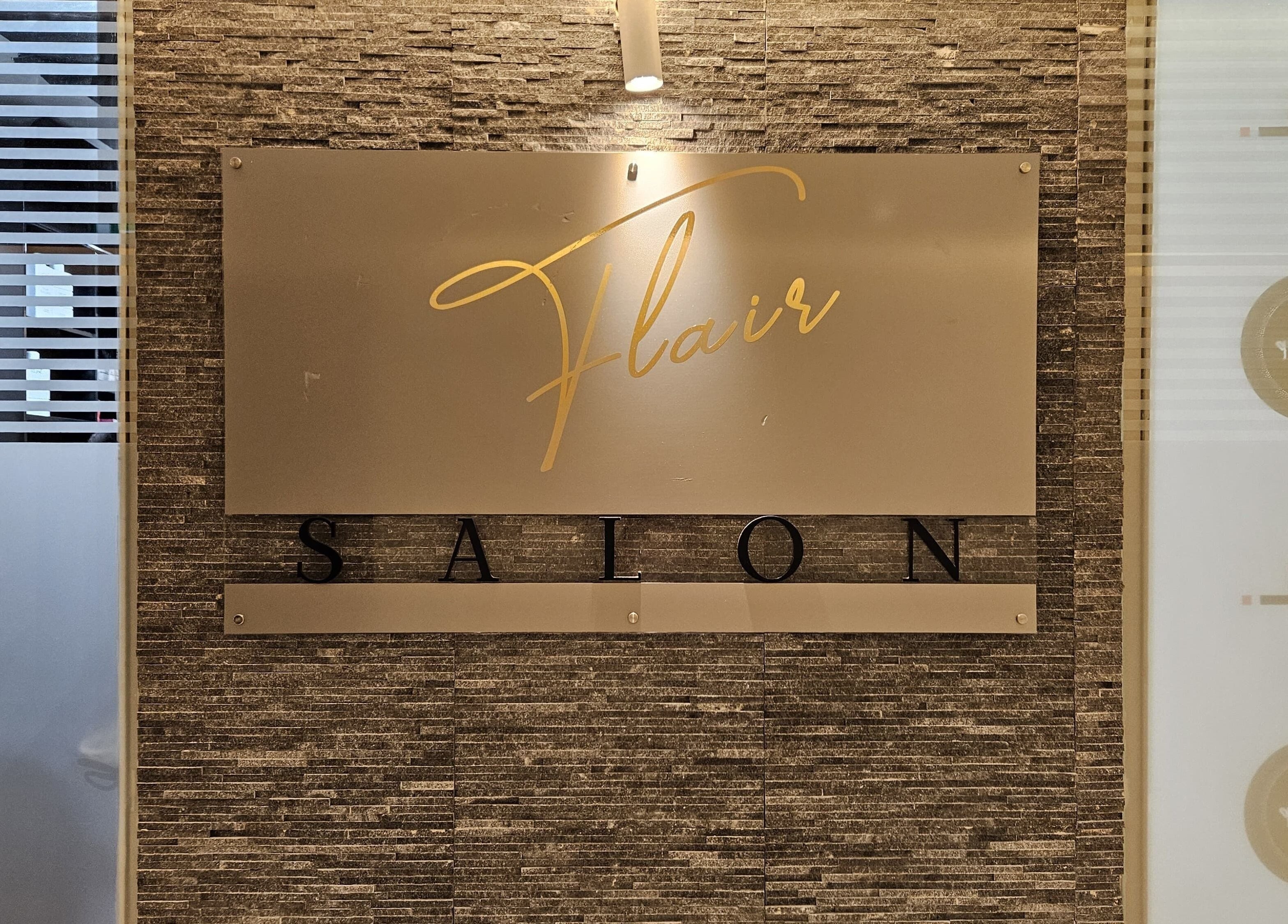 Elegant sign of Flair Beauty Salon at Abu Dhabi, Abu Dhabi, AE featuring stylish decor.