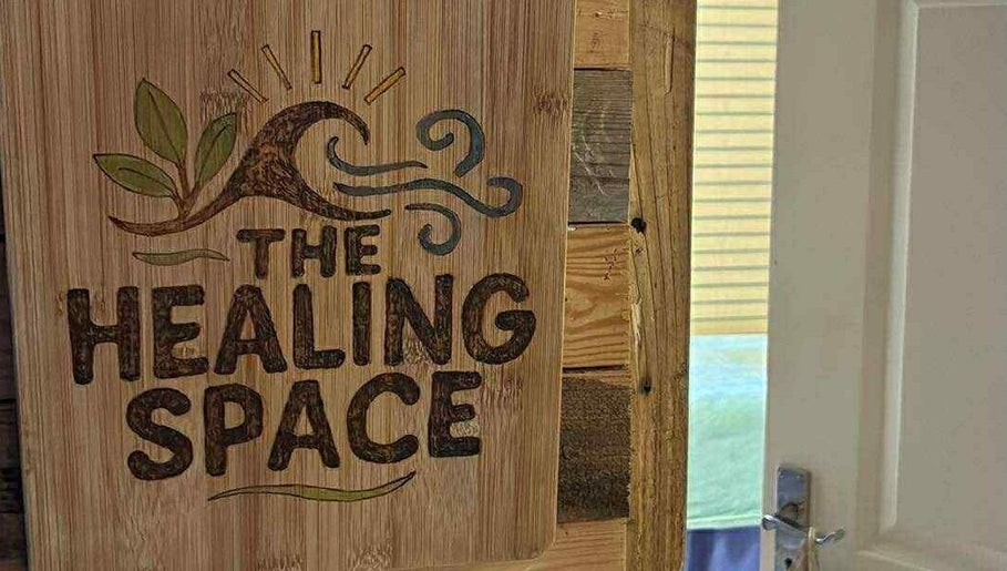 Wooden sign at Jane Sandford Hypnotherapy and Holistic Health in Liskeard, England, GB, inviting visitors to The Healing Space.
