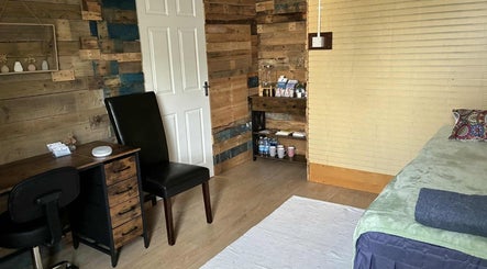 Cozy therapy room at Jane Sandford Hypnotherapy and Holistic Health, Liskeard, England, GB with a wooden desk.