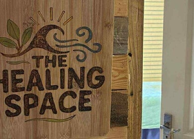 Wooden sign reading 'The Healing Space' at Jane Sandford Hypnotherapy and Holistic Health, Liskeard, England, GB.