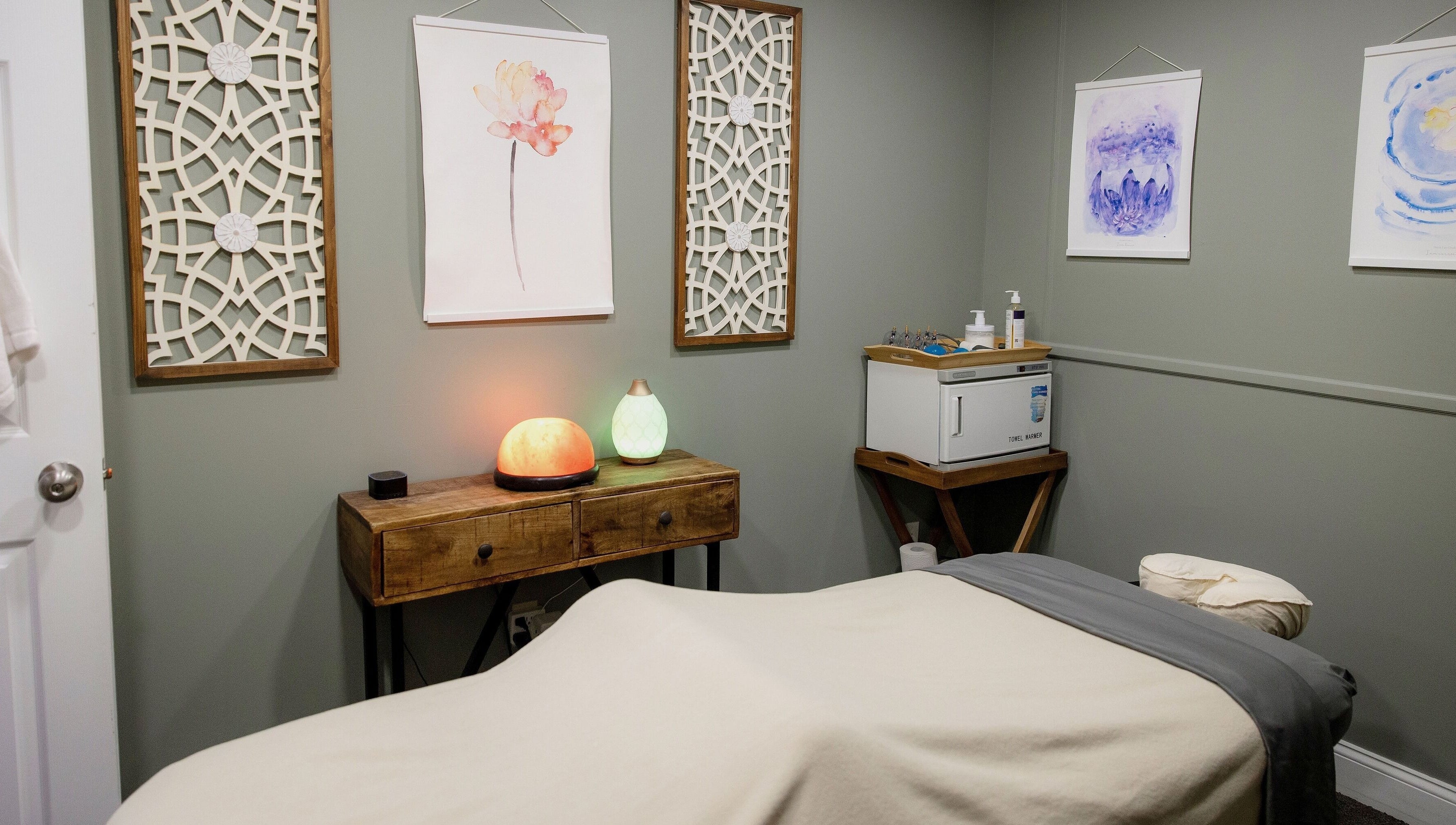 Calming massage room at The Bodhi Tree in Lancaster, New York, US with soft lighting and tranquil decor.