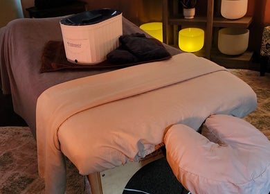 Massage room at The Bodhi Tree in Lancaster, New York, US, with a cozy table and ambient lighting.