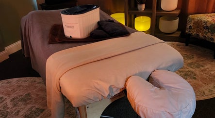 Massage room at The Bodhi Tree in Lancaster, New York, US, with a cozy table and ambient lighting.