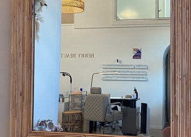 Interior of ALPENGLOW BEAUTY THERAPY in Methven, Canterbury Region, NZ, with a stylish mirror and seating.