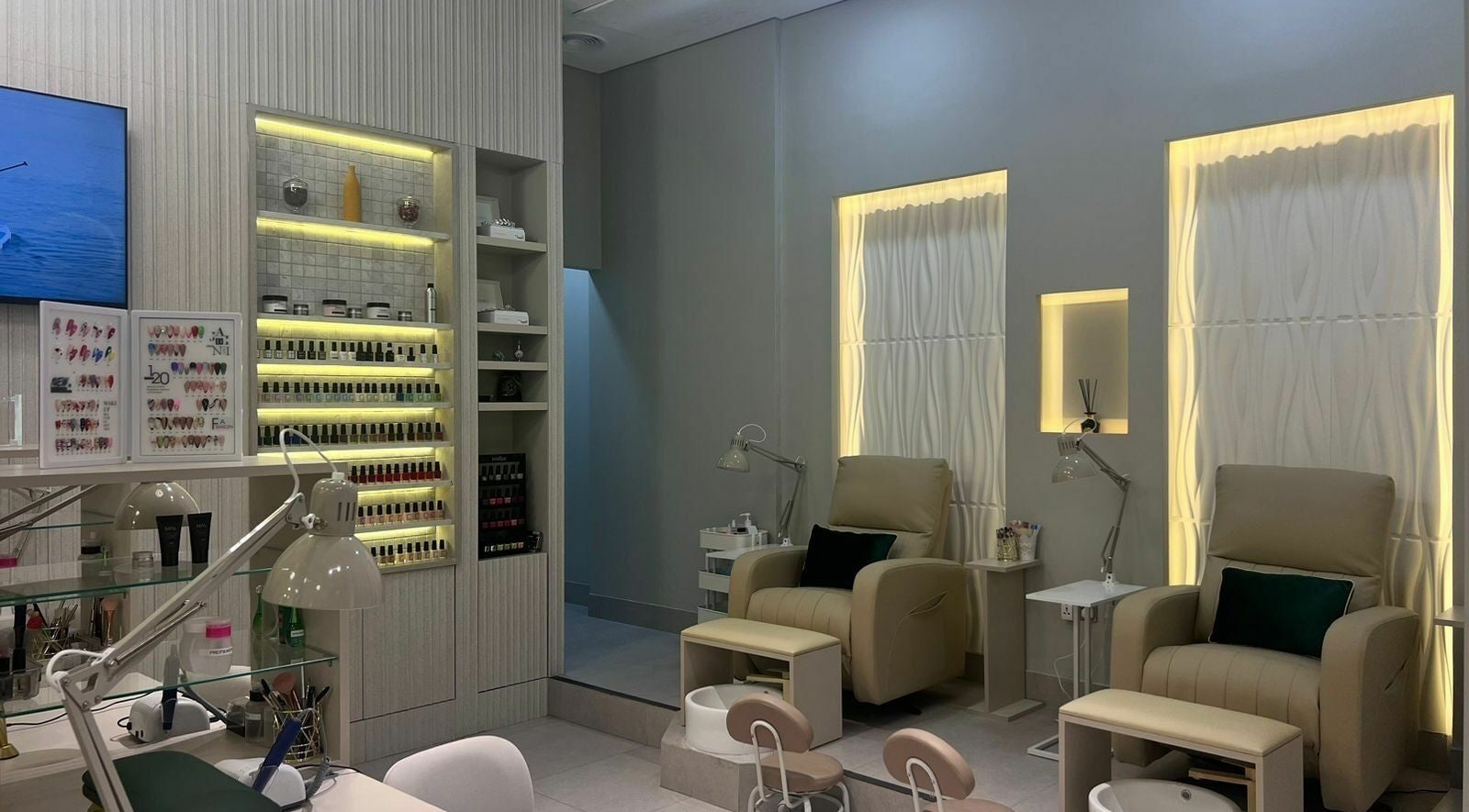 Elegant interior of Amazigh Beauty Salon in Dubai, Dubai, AE with plush chairs and nail polish display.