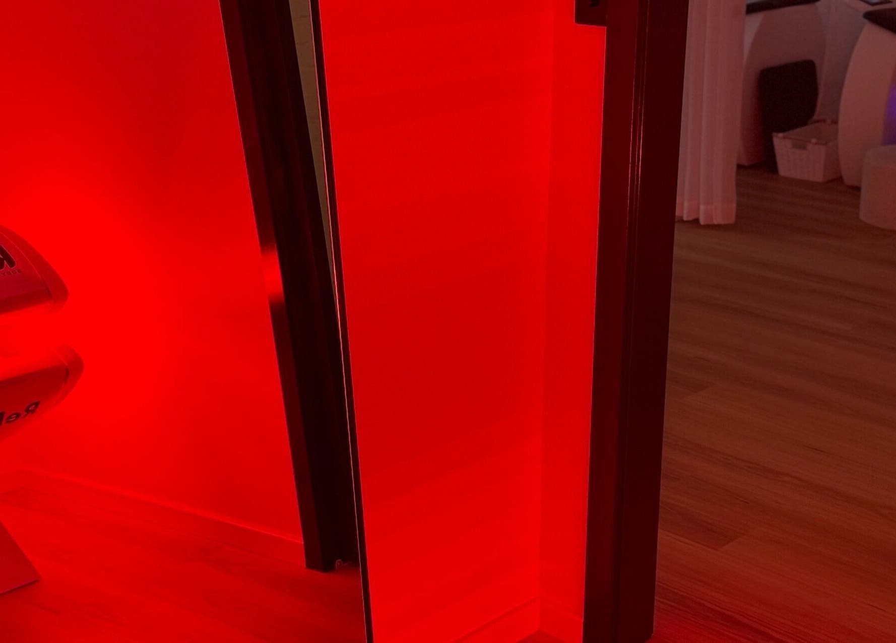 Red-lit room at Karve Body Sculpting and Recovery in Busselton, WA, showcasing a wellness treatment space.