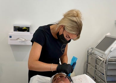 Aesthetician performing a skin treatment at Just Skin Uk, Cardiff, Wales, GB with advanced equipment.