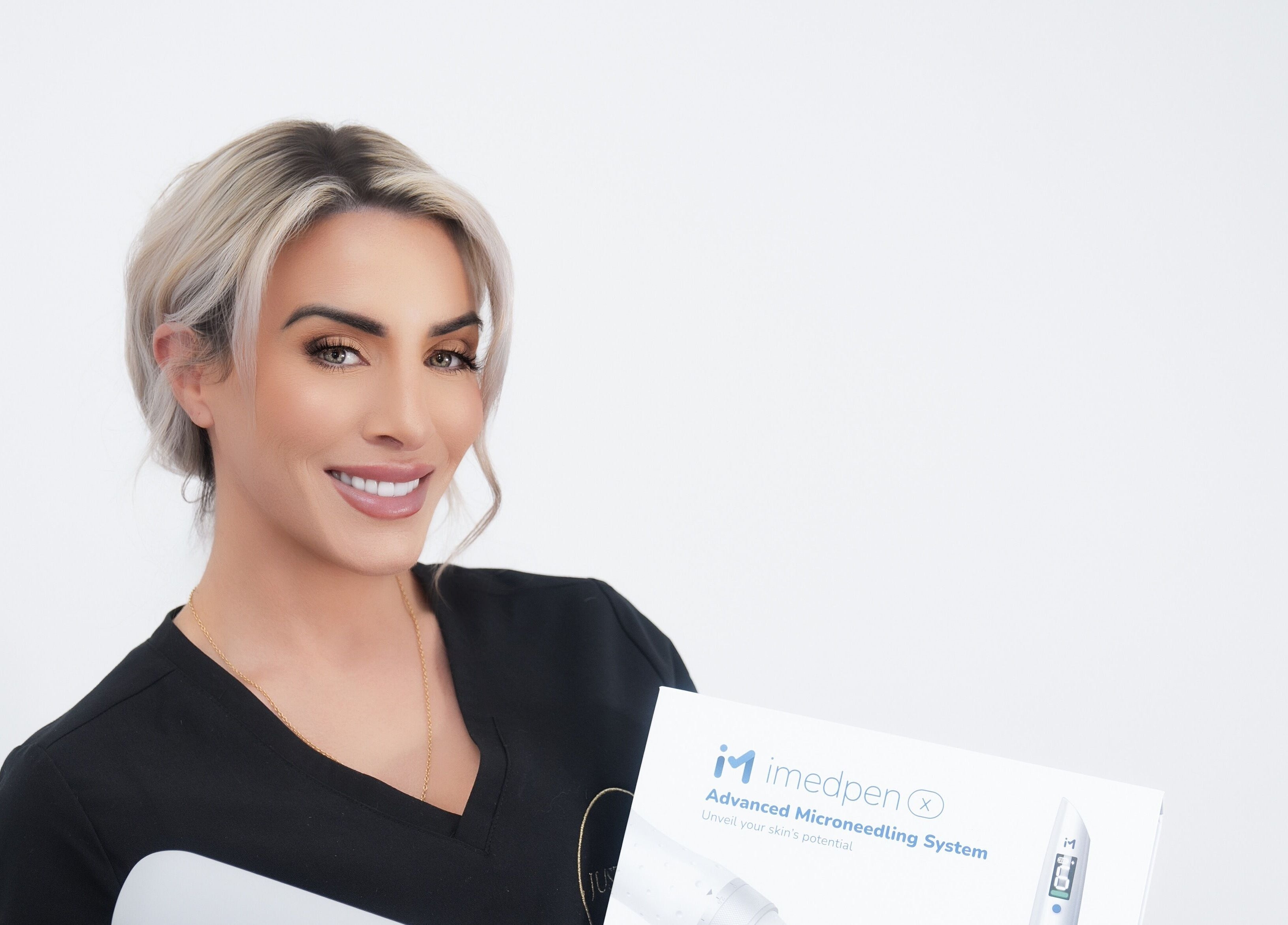 Expert at Just Skin Uk in Cardiff, Wales, GB holding advanced microneedling system for skincare treatments.