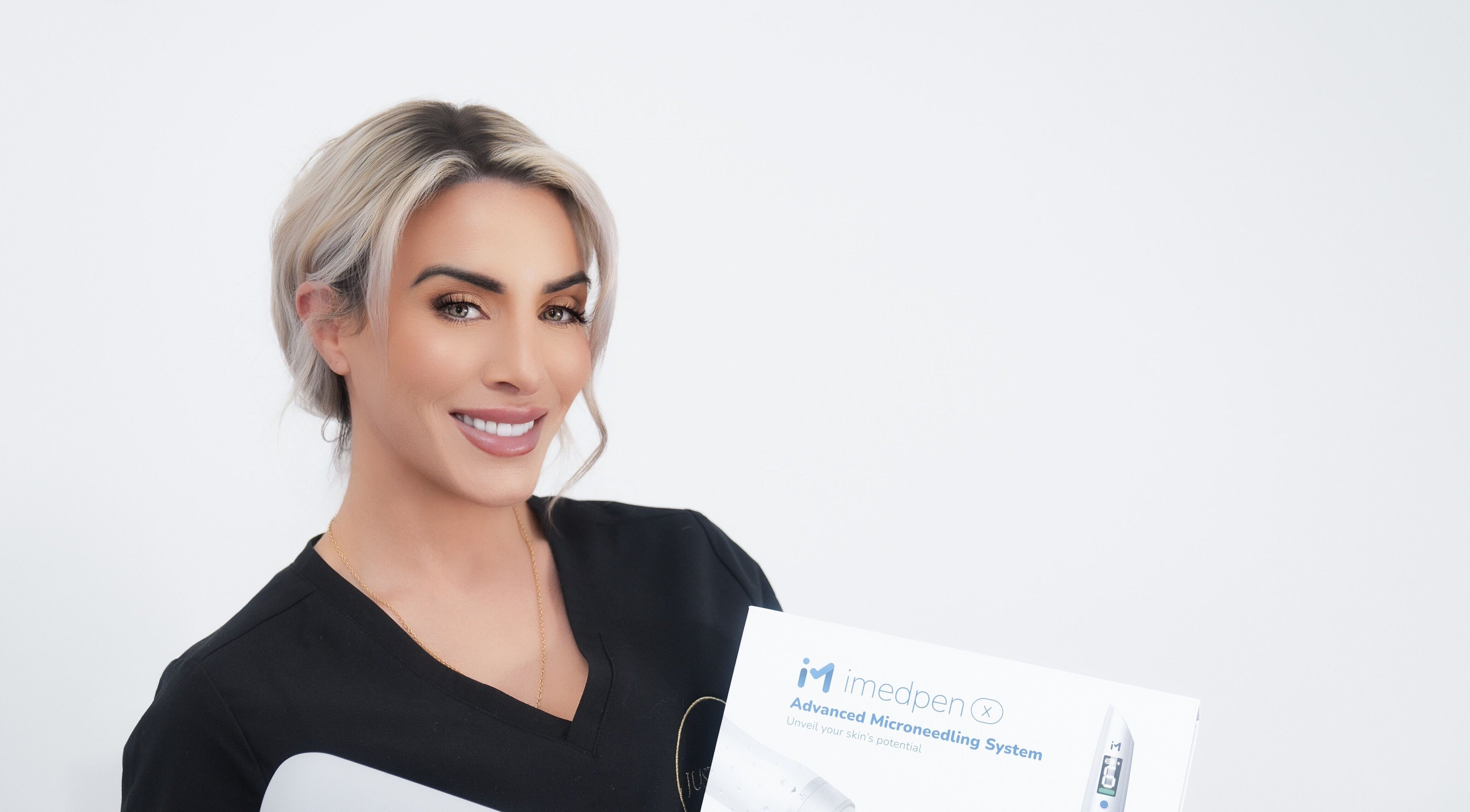 Expert at Just Skin Uk in Cardiff, Wales, GB holding advanced microneedling system for skincare treatments.