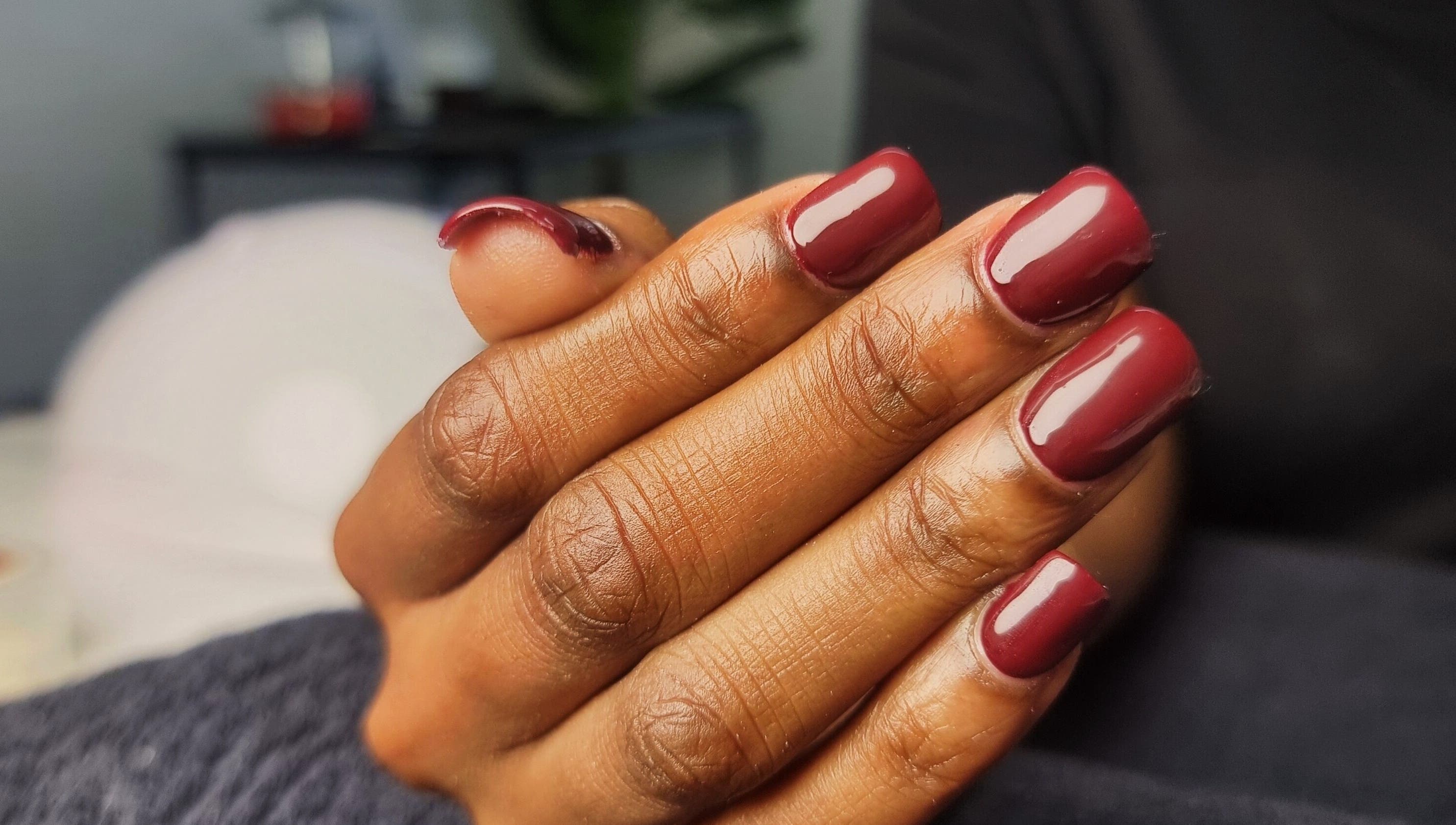 Elegant burgundy manicure at Aura Beauty, Westville, Kwazulu-natal, ZA, showcasing stylish nail art.
