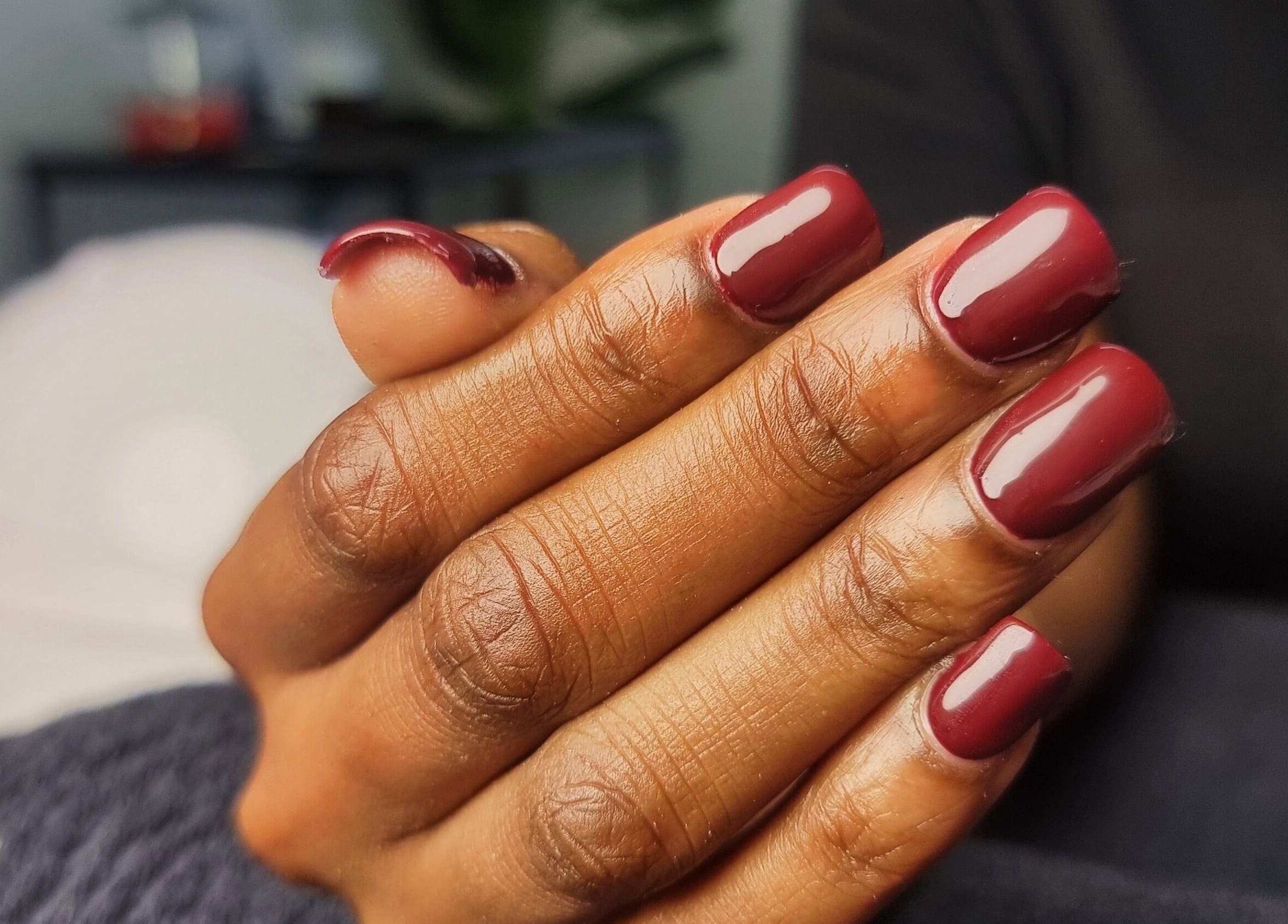 Elegant burgundy manicure at Aura Beauty, Westville, Kwazulu-natal, ZA, showcasing stylish nail art.