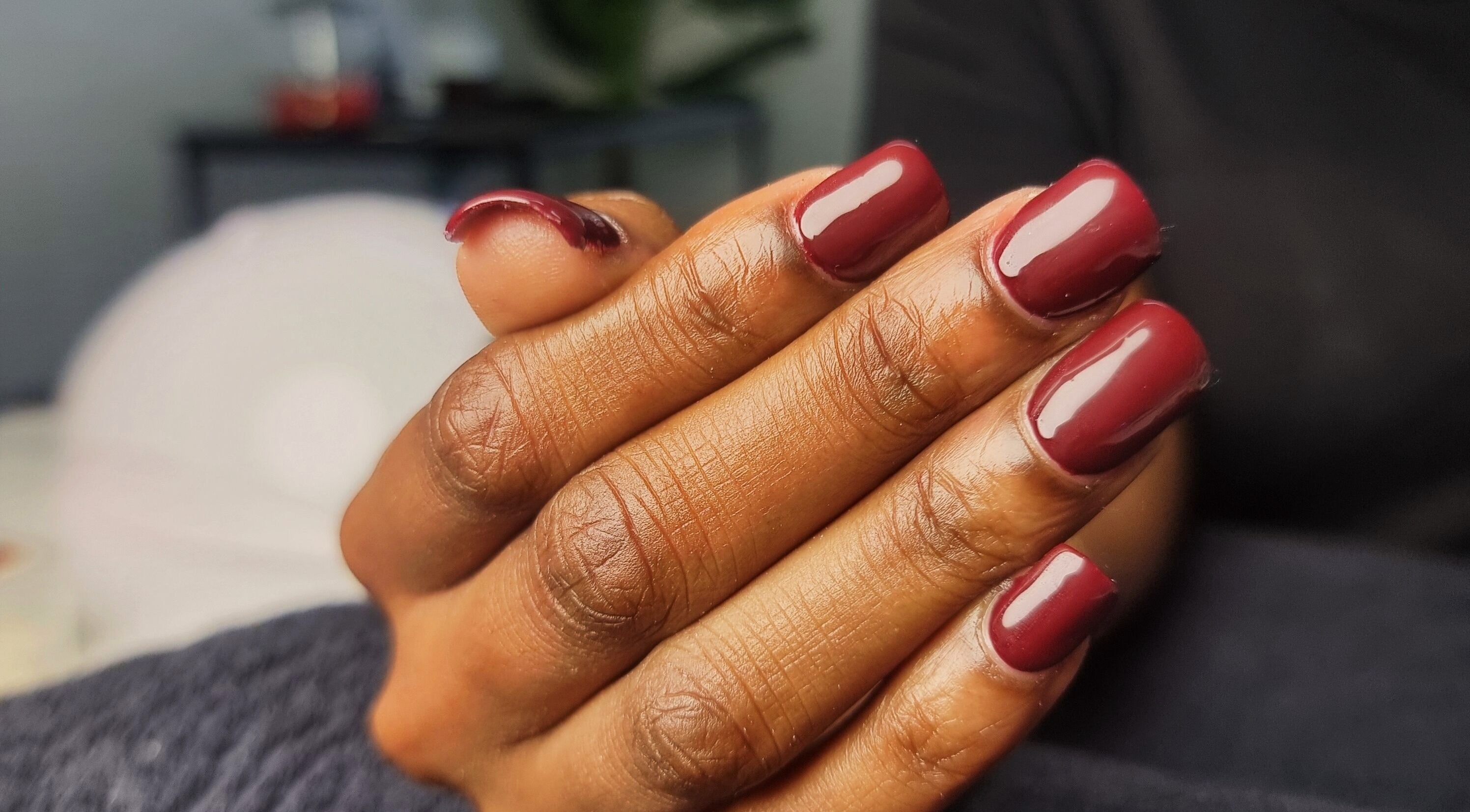 Elegant burgundy manicure at Aura Beauty, Westville, Kwazulu-natal, ZA, showcasing stylish nail art.