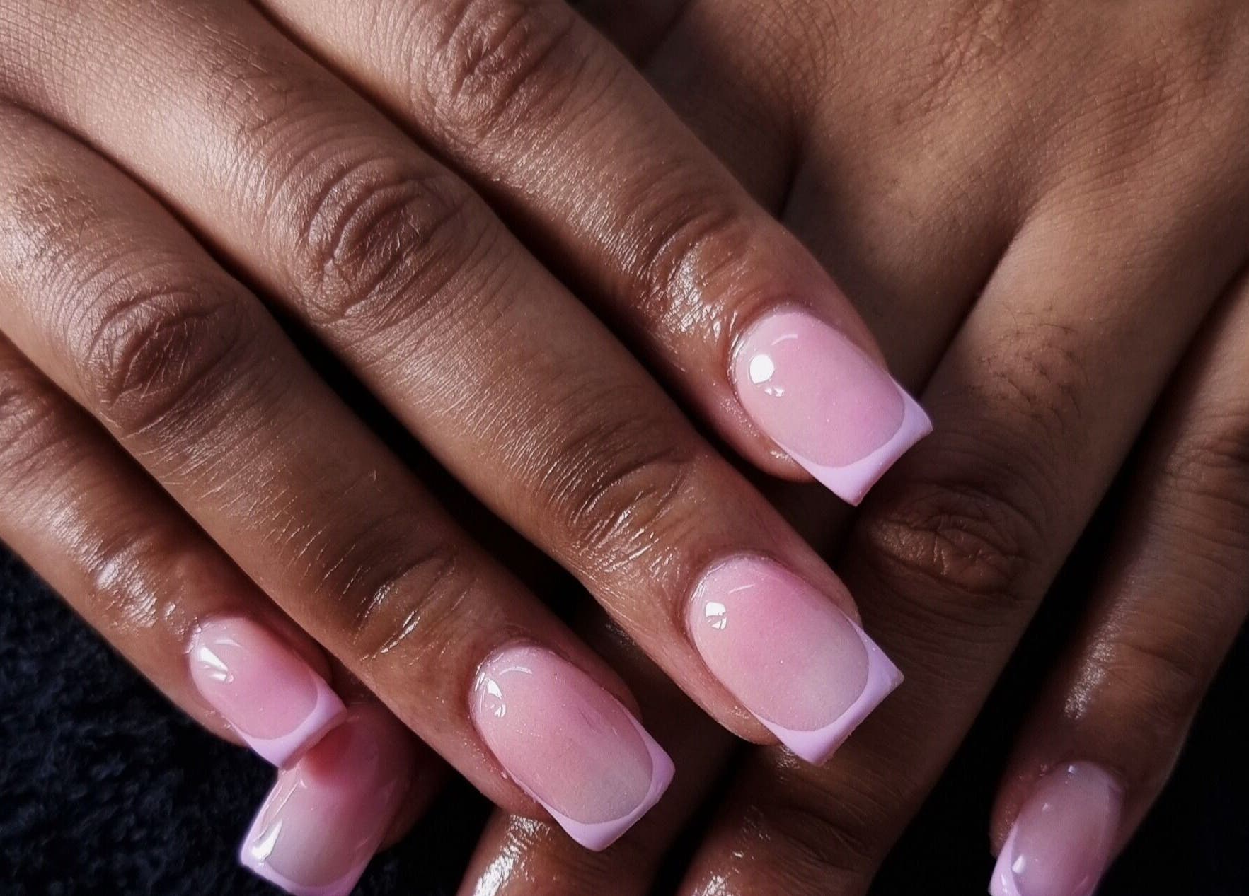 Elegant pink French nails at Aura Beauty, Westville, Kwazulu-natal, ZA showcasing manicure skills.