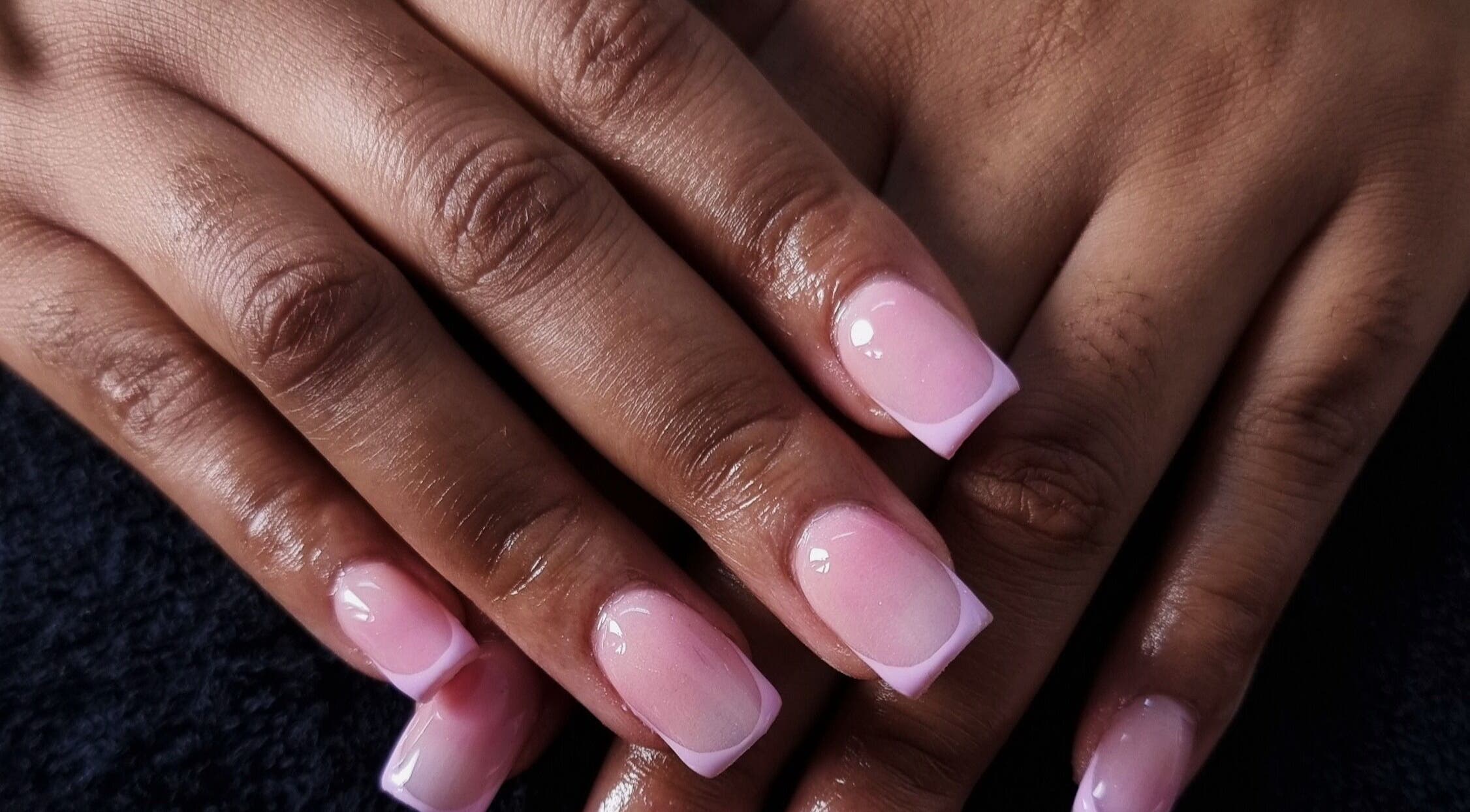 Elegant pink French nails at Aura Beauty, Westville, Kwazulu-natal, ZA showcasing manicure skills.
