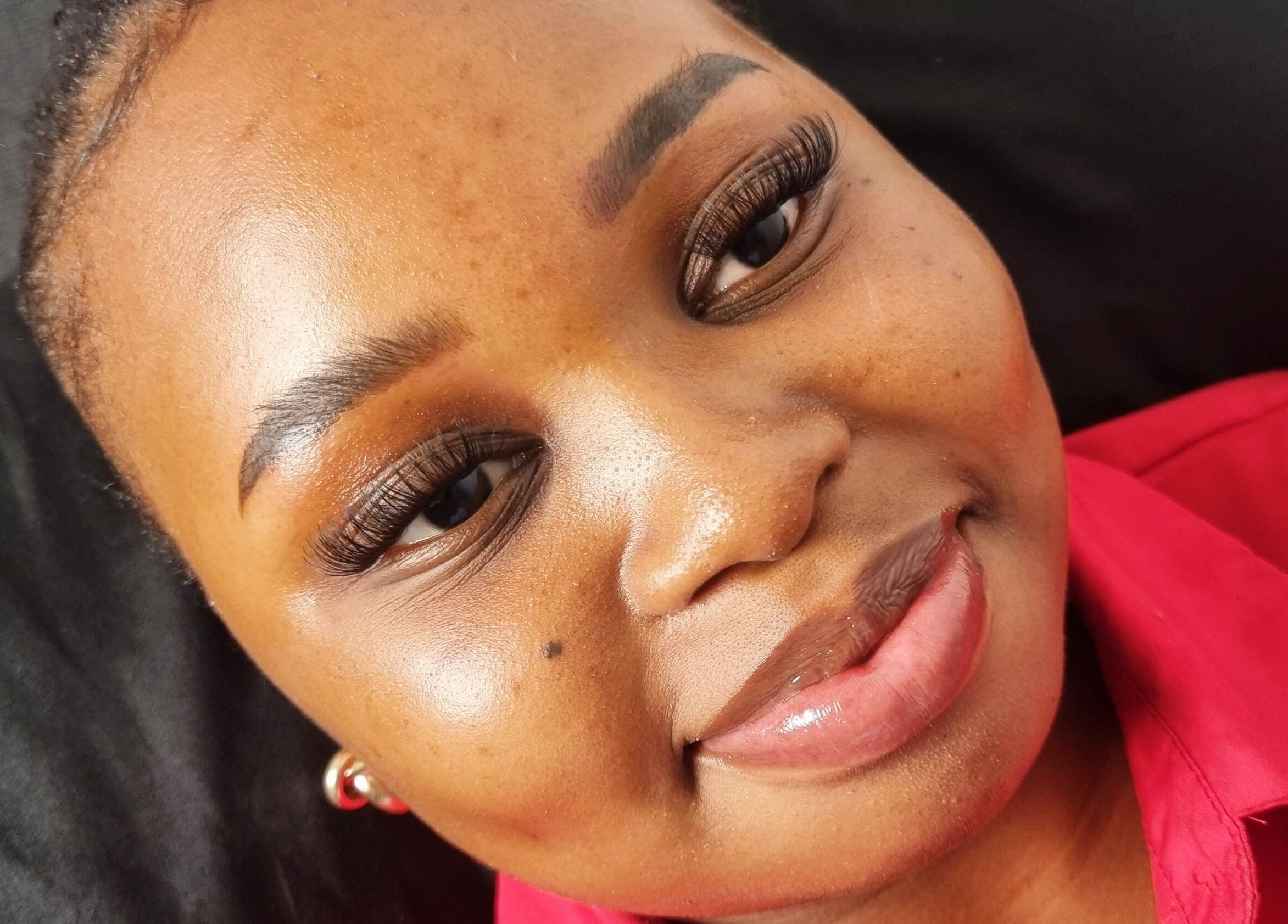 Radiant woman showcasing lash extensions at Aura Beauty, Westville, Kwazulu-natal, ZA.