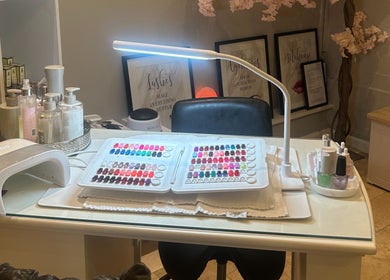 Nail station at The Ivy Rooms, Dunmow, England, GB with polish display and manicure tools.