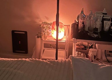 Tranquil spa setup at The Ivy Rooms in Dunmow, England with warm lighting and skincare products.