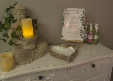 Peaceful Buddha statue and candle at The Ivy Rooms, Dunmow, England, GB. A calming space for relaxation.