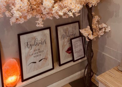 Chic decor with floral accents at The Ivy Rooms, Dunmow, England, GB, featuring stylish framed artwork.