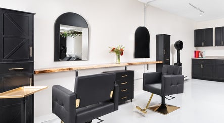 Chic interior of Rustic Roots Hair Lounge, Thorold, Ontario, CA, featuring modern salon chairs and sleek cabinetry.