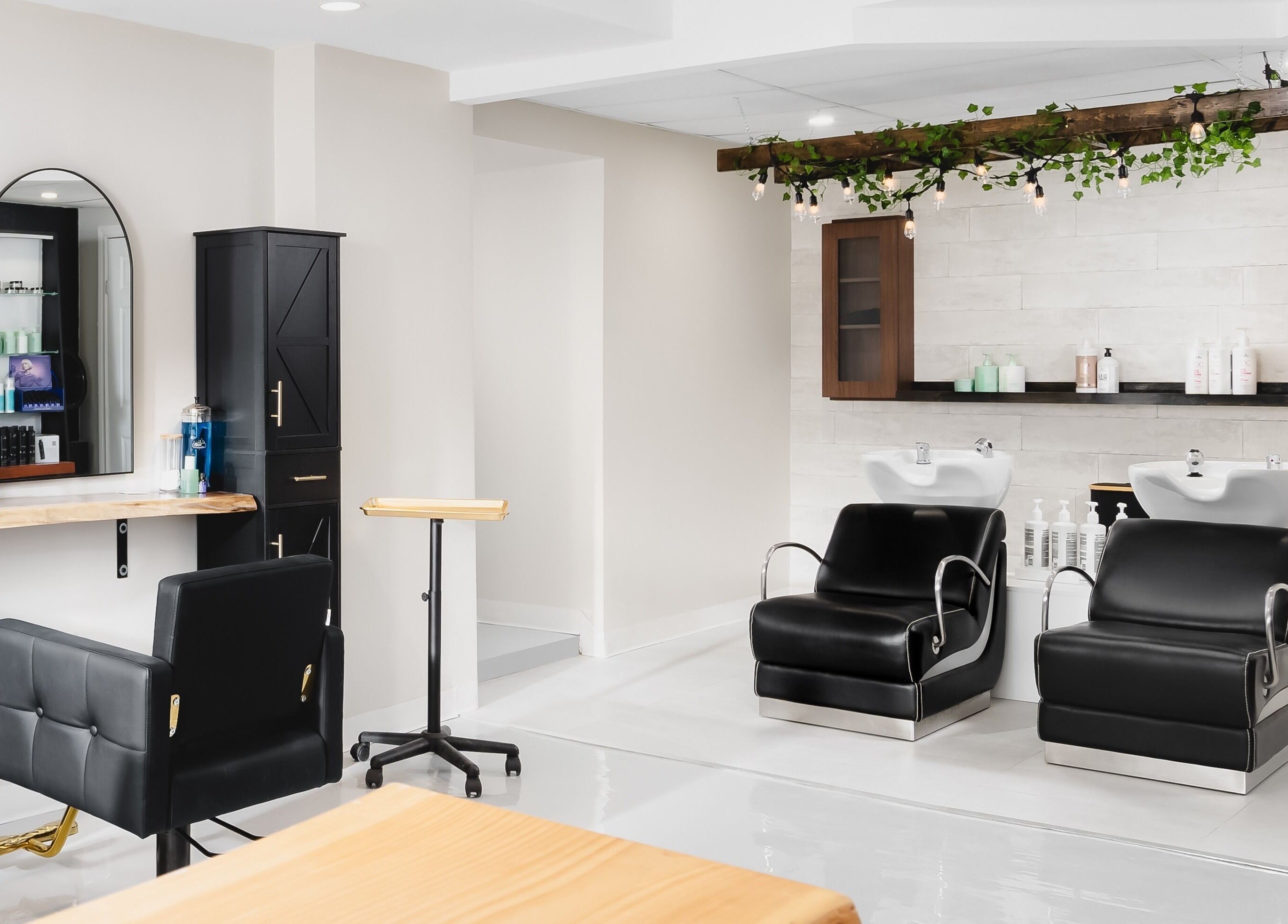 Chic interior of Rustic Roots Hair Lounge salon in Thorold, Ontario, CA with stylish chairs and modern decor.