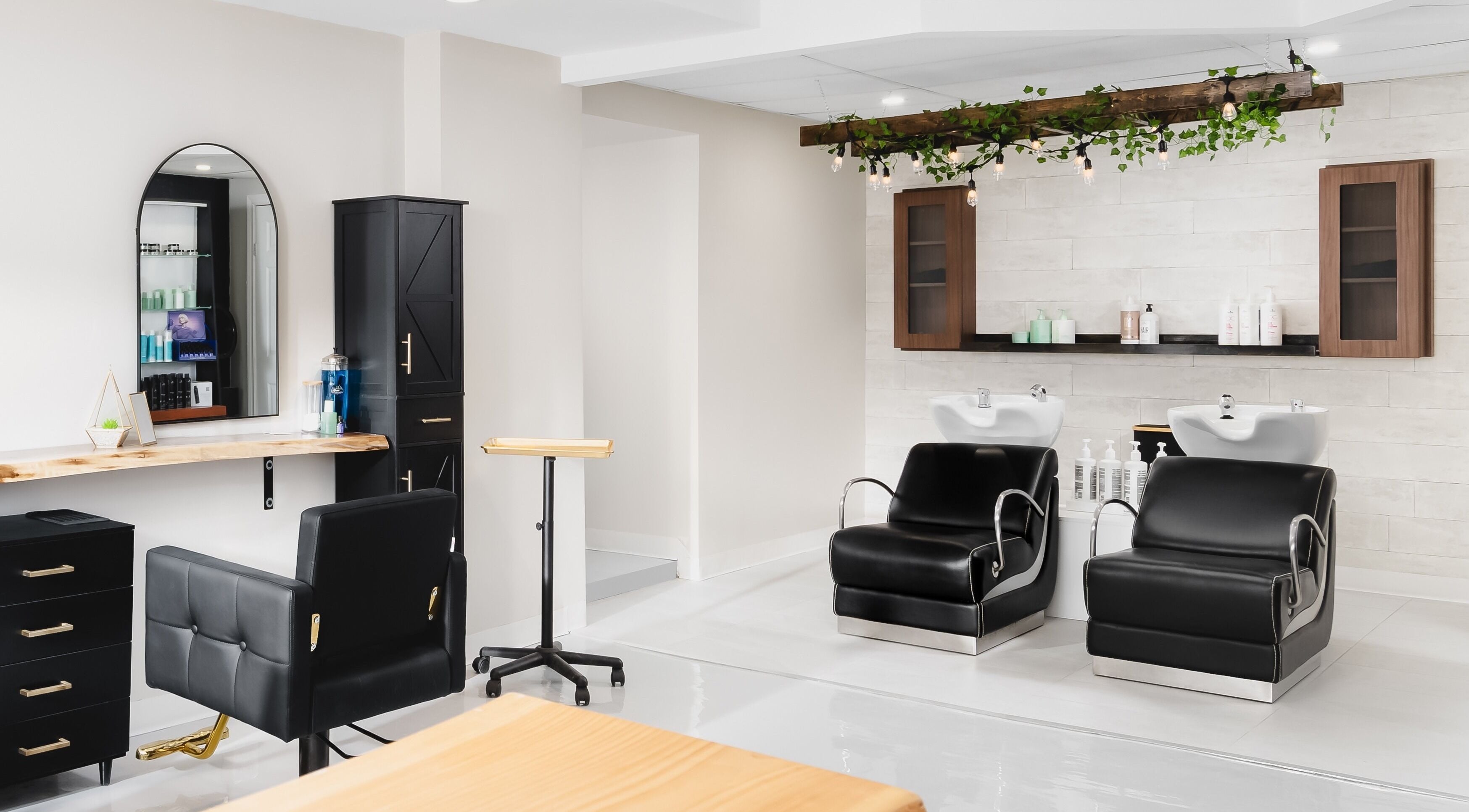 Chic interior of Rustic Roots Hair Lounge salon in Thorold, Ontario, CA with stylish chairs and modern decor.