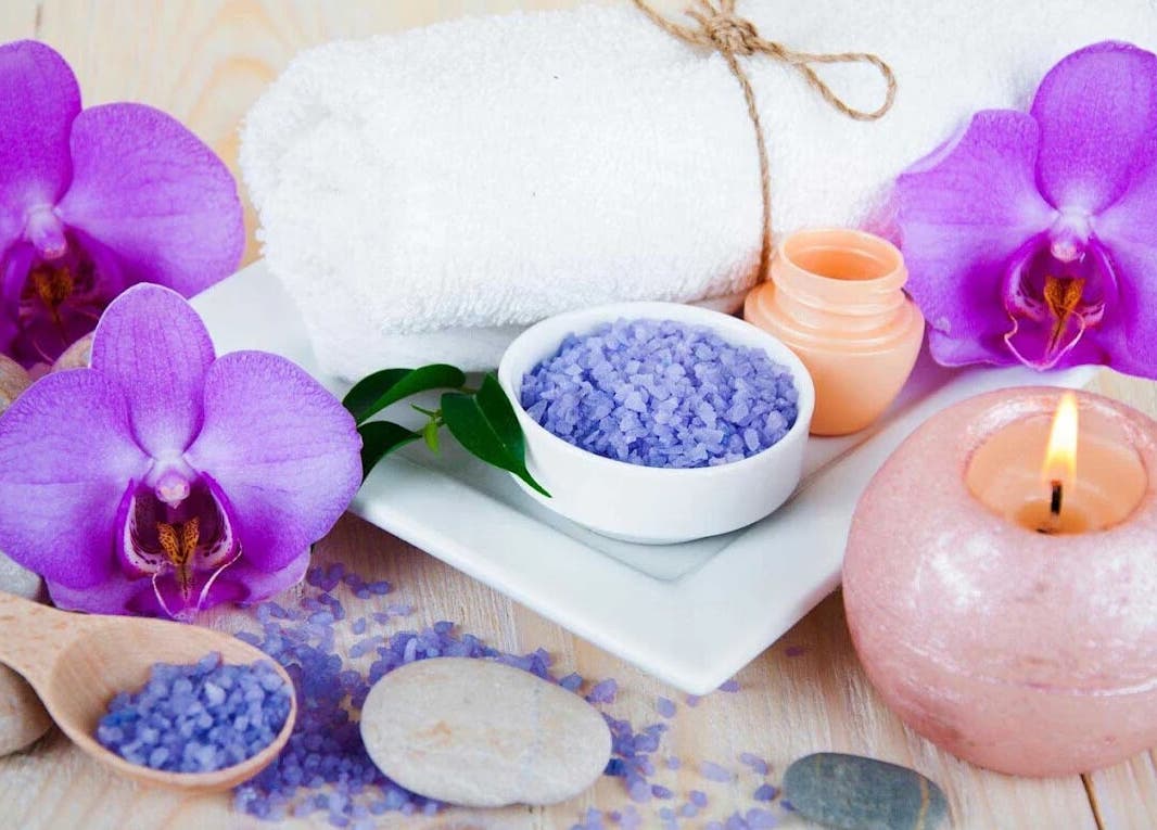 Spa setup with orchids, sea salt, and candle at Lotus Blossom Spa South, Orlando, Florida, US.