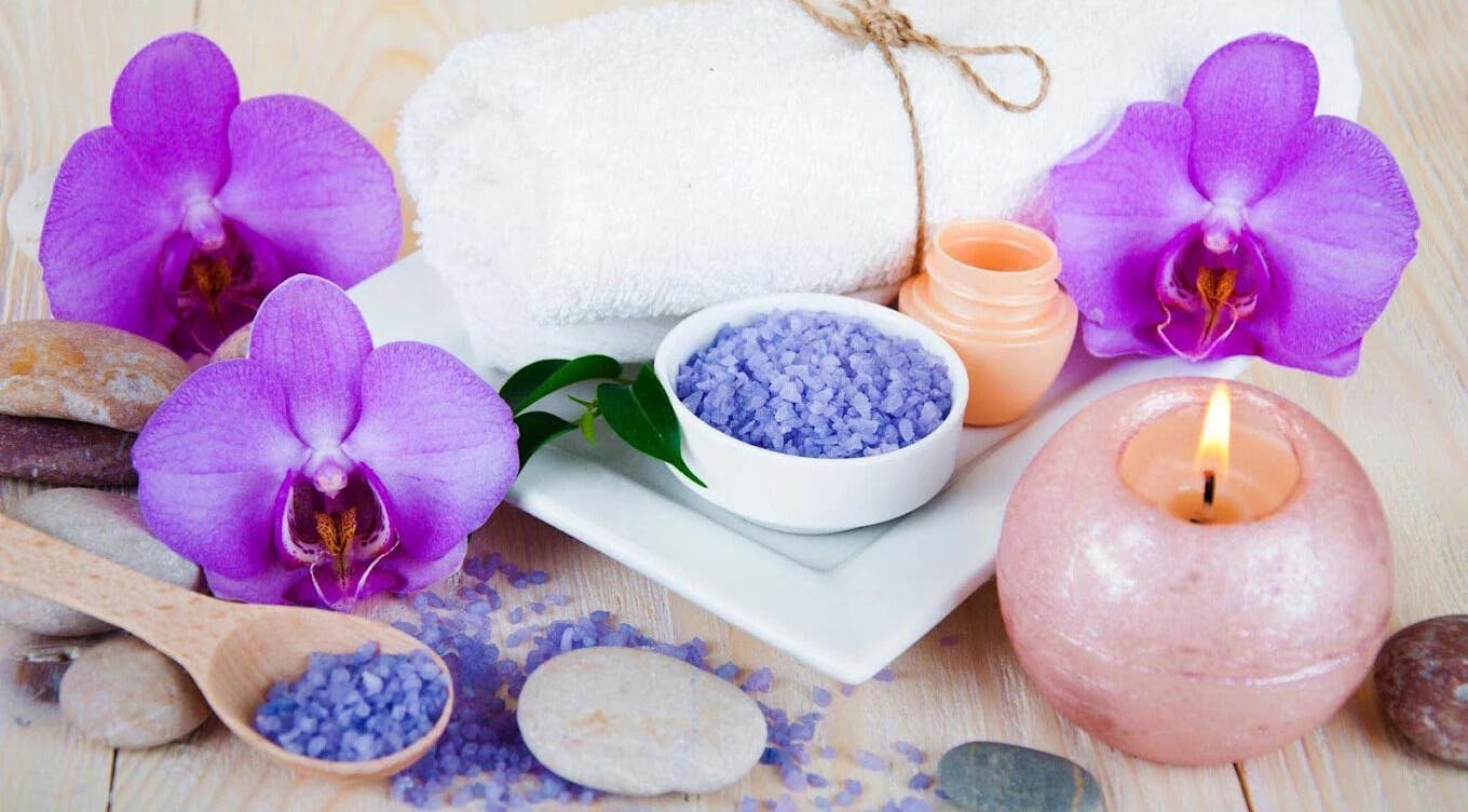 Spa setup with orchids, sea salt, and candle at Lotus Blossom Spa South, Orlando, Florida, US.