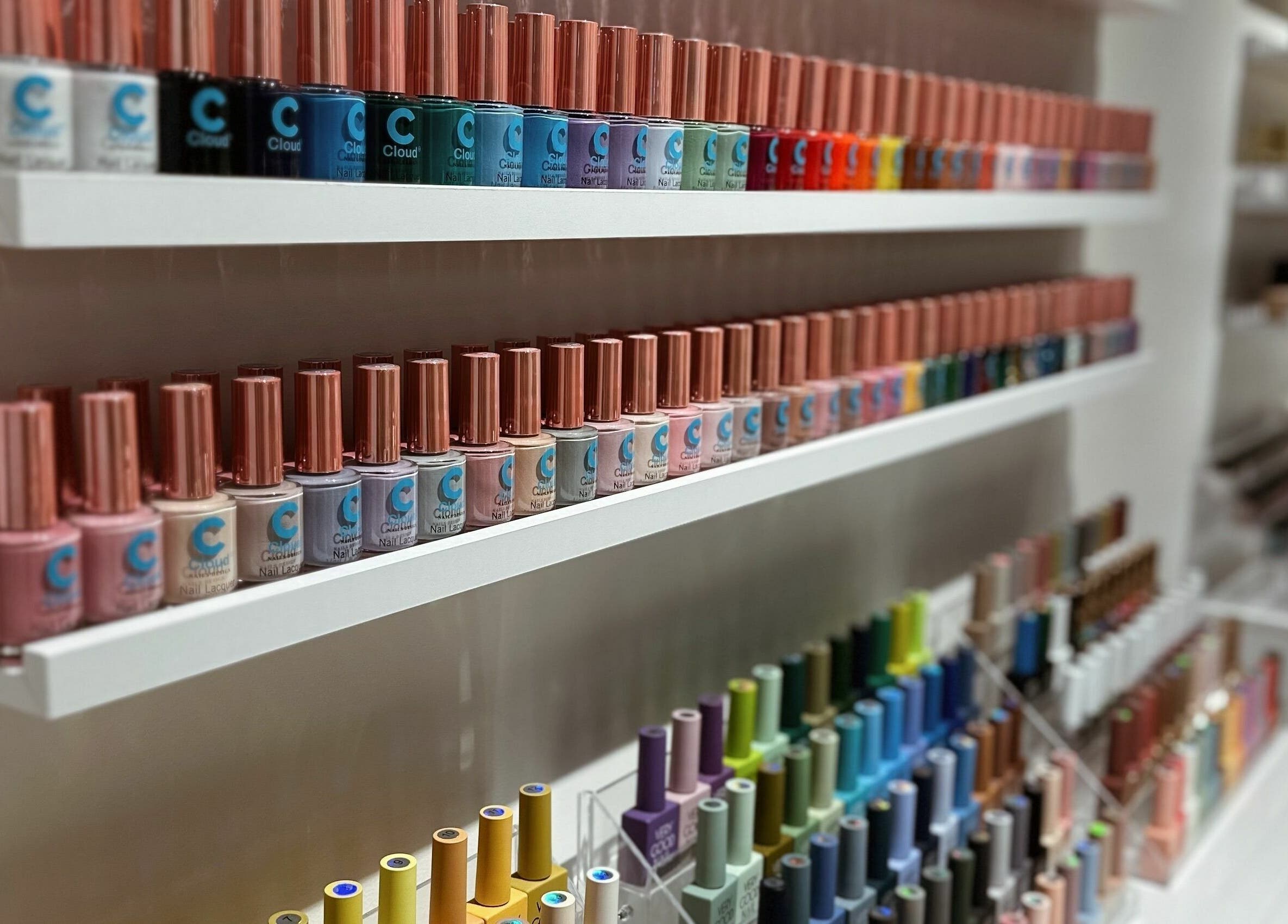 Colorful nail polish bottles neatly arranged at Cosmo Nails & Beauty, Auckland, Auckland, NZ.