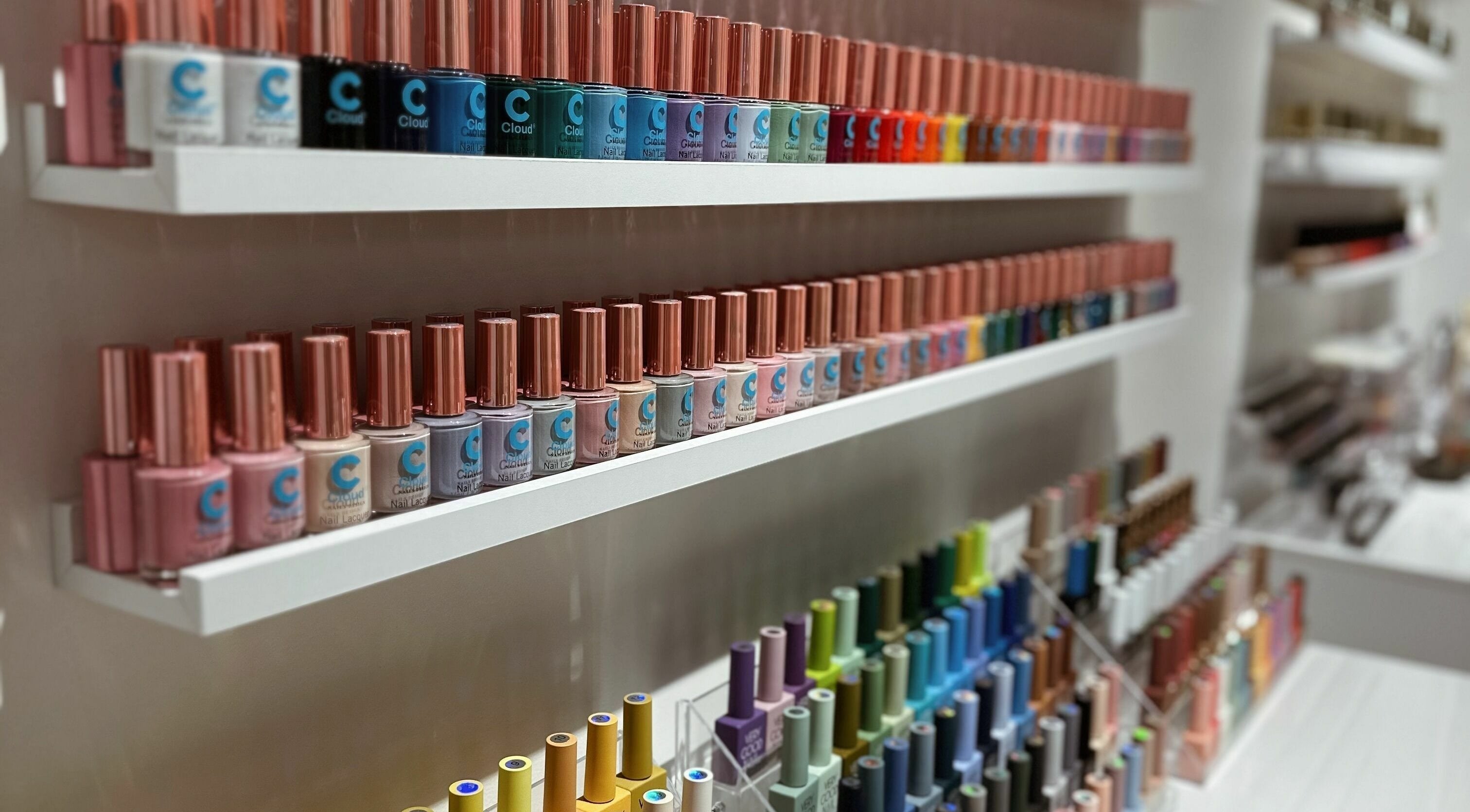 Colorful nail polish bottles neatly arranged at Cosmo Nails & Beauty, Auckland, Auckland, NZ.